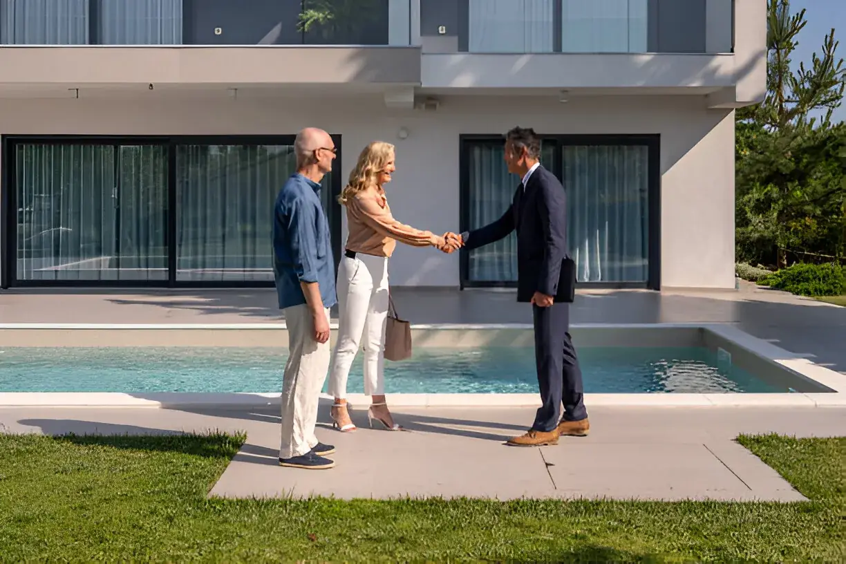 A realtor meeting clients at a home