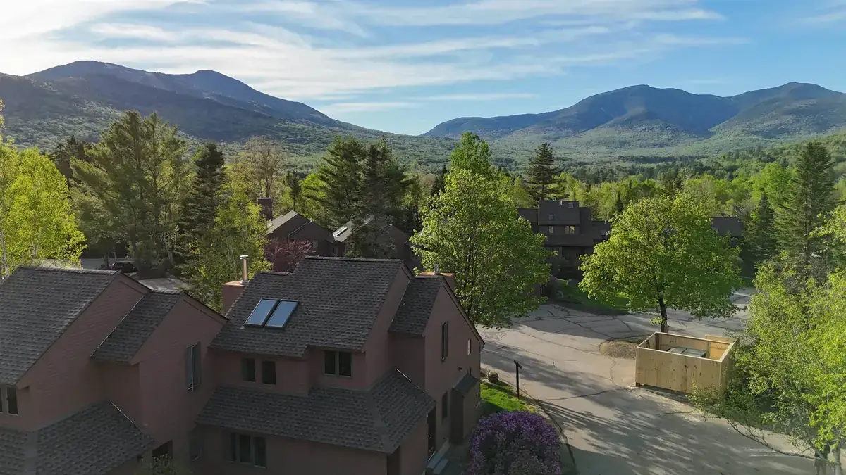 Townhomes on the Waterville Valley floor with forested White Mountain peaks rising on every side
